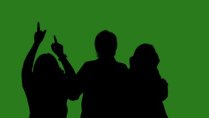 Black isolated silhouettes of people dancing cheerfully on a green chroma key background. Minimalist contrast and modern visual composition, mockup.