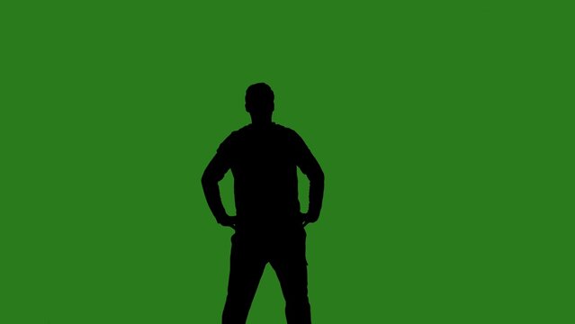 A black silhouette of a man dances cheerfully against a green chroma key background. Minimalist contrast and modern visual composition, mockup. - Powered by Adobe