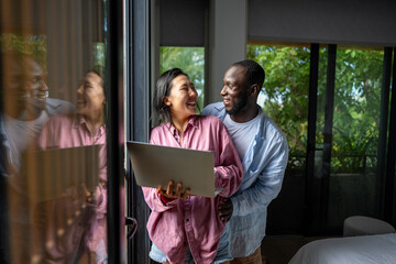 Man and woman working remotely using laptop. Male female freelancers working together. Digital nomad