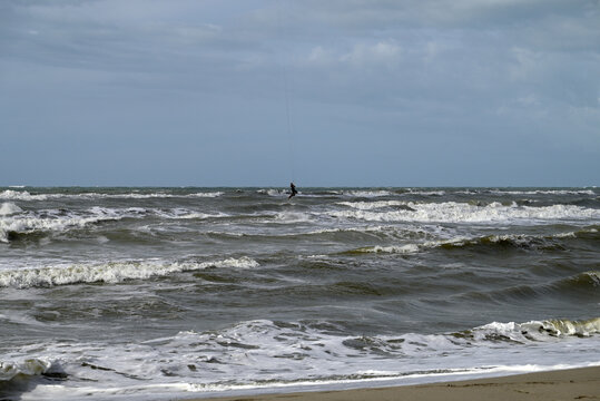 Kitesurfing at italian beach. Some kitesurfers at Torre del Lago beach, tuscany, italy. Some are junping out of the water. Mediterraenean Sea.