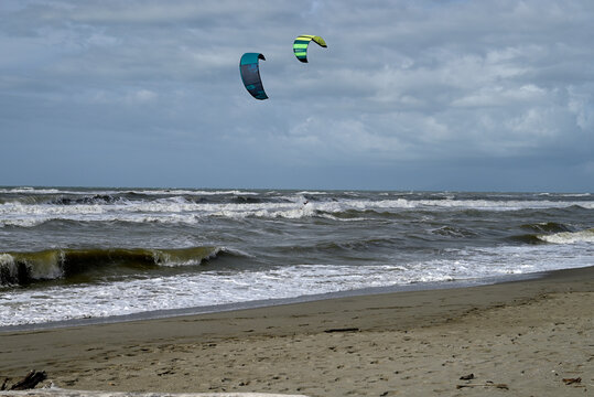 Kitesurfing at italian beach. Some kitesurfers at Torre del Lago beach, tuscany, italy. Some are junping out of the water. Mediterraenean Sea.
