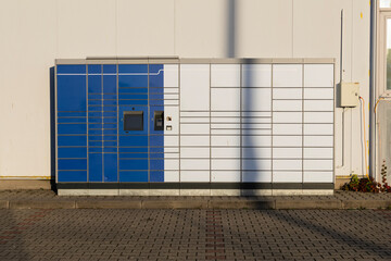 Automated parcel locker outdoors in sunlight
