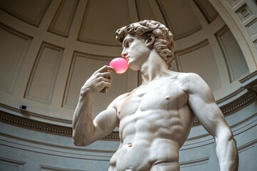 White marble statue holding pink bubble gum