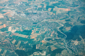  Prut River has border between Romania and Moldova, view from above. Aerial view showcasing a densely populated town situated along meandering river