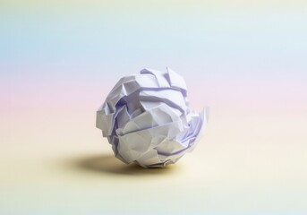 Fototapeta premium A single crumpled paper ball symbolizing a mistake or a discarded idea. Creative process and brainstorming concept on a colorful pastel background