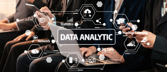 This image captures a team of professionals engaged in data analytic processes, showcasing technology and visualization techniques to derive insights and trends in a business environment. Amity