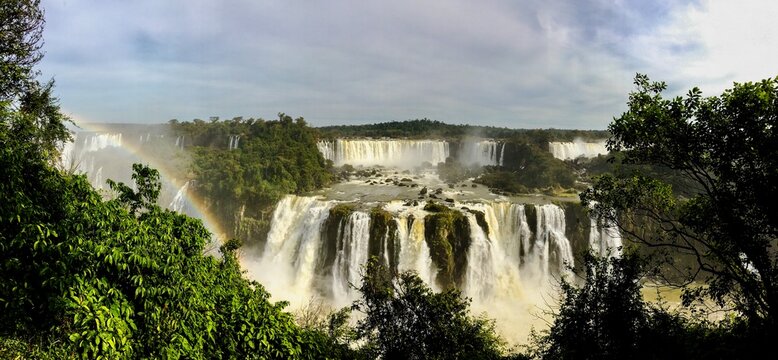 Majestic waterfall cascading over rocky cliff into pool