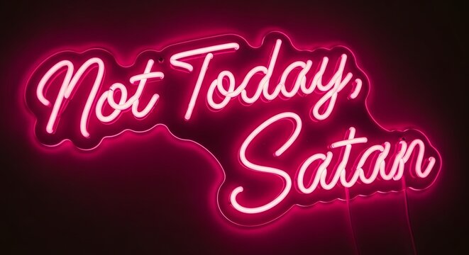 A vibrant neon sign displays the message 'Not Today, Satan' in bright pink cursive letters against a dark background, creating a bold and eye-catching visual statement