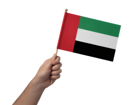 Hand waving the United Arab Emirates flag proudly, celebrating national pride and cultural identity on independence day