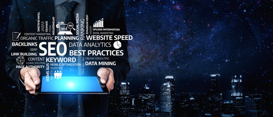 A business professional showcases a tablet displaying essential keywords for SEO and digital...