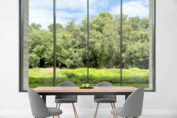 Fototapeta premium Table and chairs near window in room. Interior design
