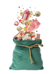 Christmas balls, gift boxes, candy cane and confetti falling into green Santa bag on white background