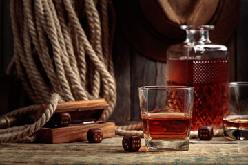 Ehiskey and dice on a old wooden table.