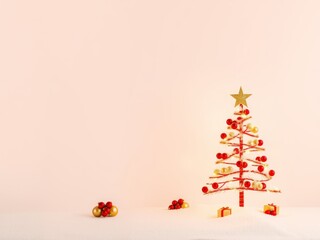 Minimalist decorated christmas tree with golden star and gifts