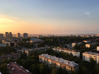 Fototapeta premium Wide view of Ufa with residential buildings, circus and a ferris wheel in the distance. Modernization, harmony, and rhythm of urban life.