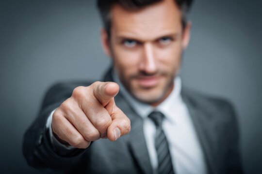 Businessman pointing forward assertively, emphasizing focus and direction during presentation.
