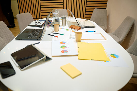 Office meeting table with laptops and business documents - Powered by Adobe