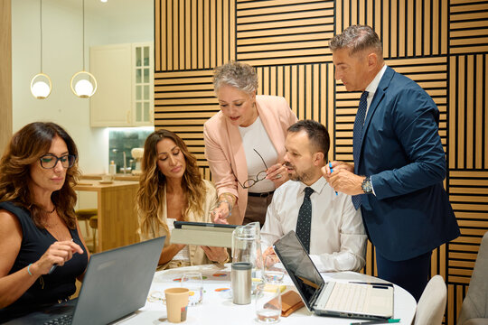 Business team collaborating on project during office meeting