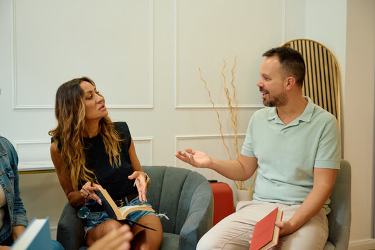 Group of friends discussing book club literature