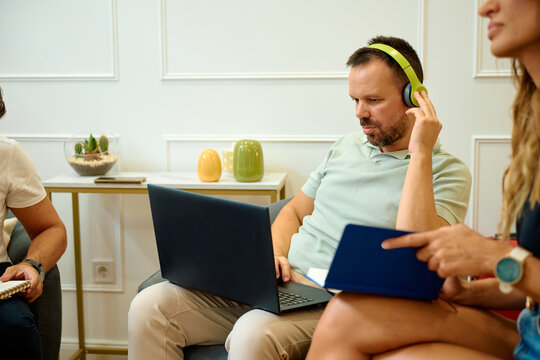 Colleagues collaborating and discussing work in office setting