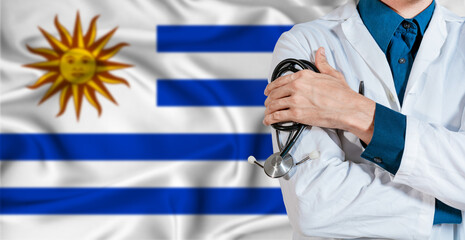 Fototapeta premium Uruguay healthcare concept. Doctor with stethoscope on Uruguay flag. Doctor holding stethoscope on Uruguayan flag