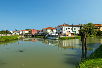 Italian town buildings lining canal in Venice, Veneto