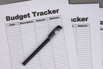 Open daily planner notebook on desk, with organized Monthly Budget tracking table. With dates, categories and expenses. Personal finance management, spending and budgeting habits concept.