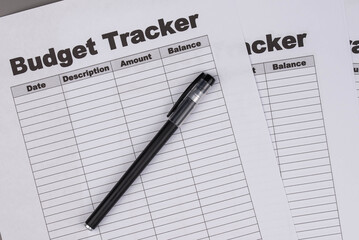Open daily planner notebook on desk, with organized Monthly Budget tracking table. With dates, categories and expenses. Personal finance management, spending and budgeting habits concept.