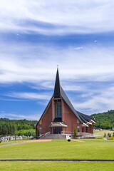 Parish church building standing against blue sky in Jasienica Rosielna, Poland