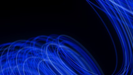 Obraz premium Blue light trails curve and overlap on a black background. Abstract long-exposure effect creates a sense of motion, energy, and futuristic digital flow.