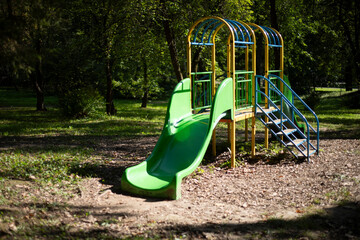 Slide for children in the park. Children's playground in nature. Autumn weather.