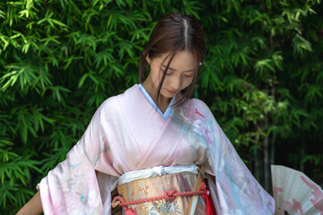Young Japanese woman in colorful traditional kimono clothing 
