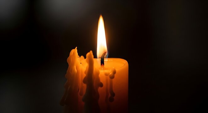 Close-up of a Bright Burning Candle Flame with Melted Wax Against a Dark Background - Powered by Adobe