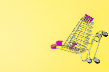 shopping cart isolated on pink background