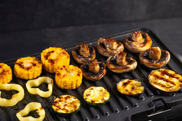 Colorful vegetables cooking on an electric grill