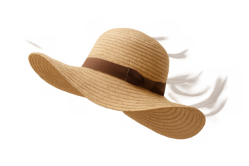 Straw sun hat flying in windy summer weather, a classic accessory for beach days and vacations, transparent background