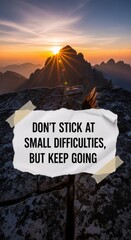 Inspirational quote on paper with mountain sunrise background. Motivational message for overcoming challenges. Business success and personal development.