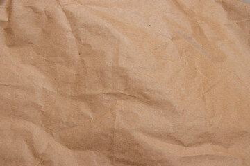 A close-up view of crumpled brown paper showcasing texture and depth. This image emphasizes the natural qualities of recycled materials, suitable for artistic and ecological projects.