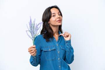 Young hispanic woman holding lavender isolated on white background proud and self-satisfied