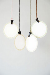 simple hanging lights with colorful cords against white background