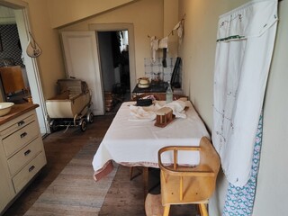 Vintage domestic interior with high chair and pram