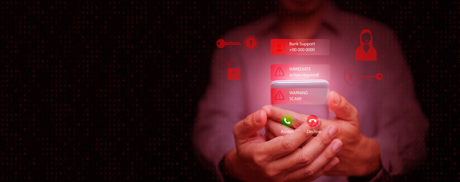 A man holding smartphone with hacking scam warning and fake bank support message, phishing, online fraud, cybersecurity awareness, call center scammer, identity theft, online security threats. - Powered by Adobe