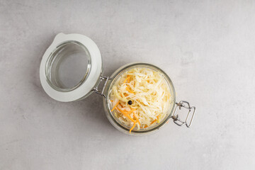 Pickled cabbage. Sauerkraut with carrots in a glass jar.