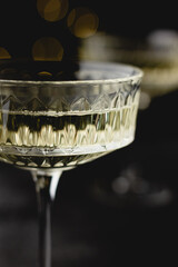 Sparkling champagne glass with warm golden lights