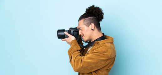 Photographer man over isolated blue background