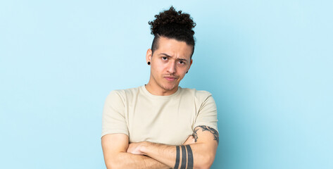 Caucasian man over isolated background with unhappy expression