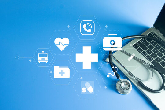Healthtech and Telemedicine concept. Stethoscope on a laptop with a virtual interface of medical icons (heart, cross, ambulance), symbolizing online doctor consultations.Top view with copyspace.