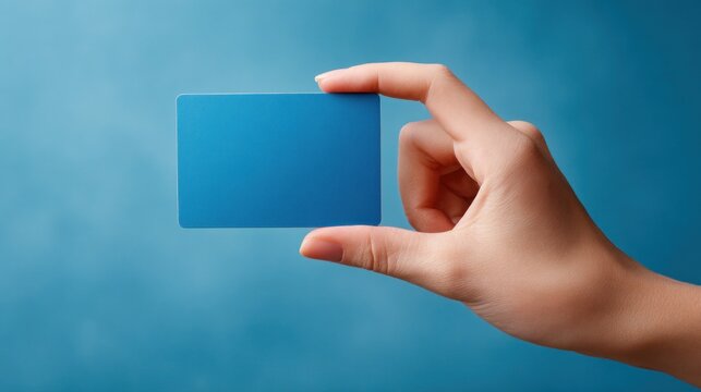 Human hand holding modern blue credit card showing payment finance banking transaction purchase shopping commerce business - Powered by Adobe