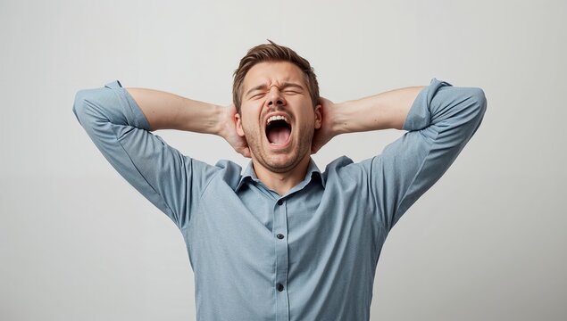 Frustrated man with hands on head screaming in exasperation, conveying stress and overwhelming pressure