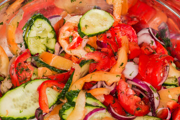 Vegetable salad in stainless steel kitchen bowl, fragment close-up